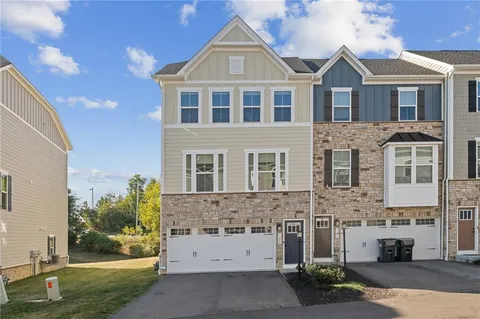 a view of a brick house with a yard