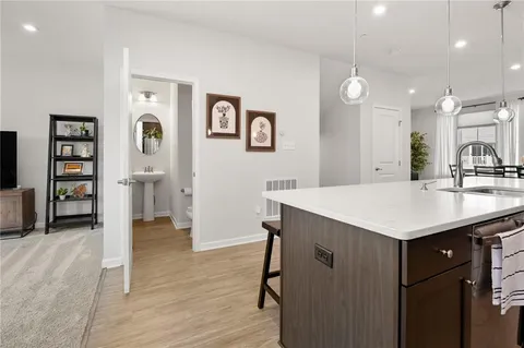 a kitchen with a sink cabinets and wooden floor