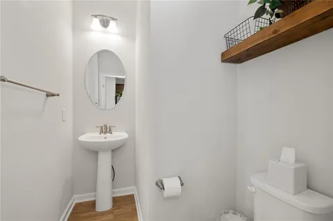 a bathroom with a sink a mirror and toilet