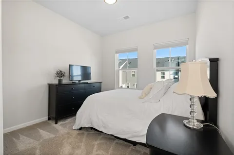 a bed room with a bed and a night stand