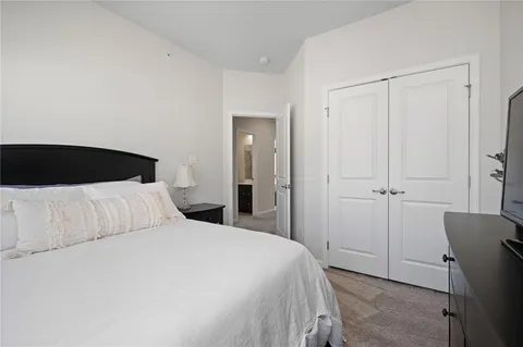 a bedroom with a bed and a closet