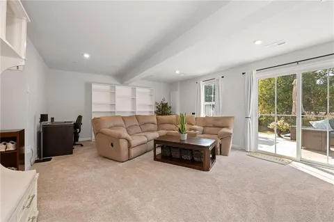 a living room with furniture and large windows