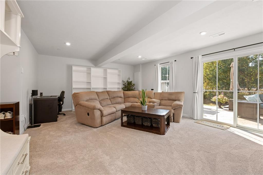 7208 Chestnut Way Gibsonia, PA 15044 - Photo 32 of 50 First floor media room with easy access to outdoor patio.