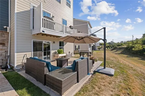 a view of two chairs and table in the patio