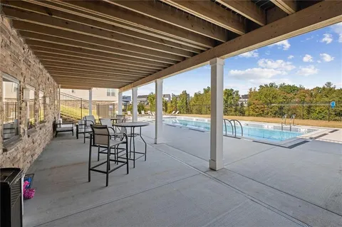a view of a patio with a table chairs and backyard