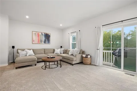 a living room with furniture and a large window