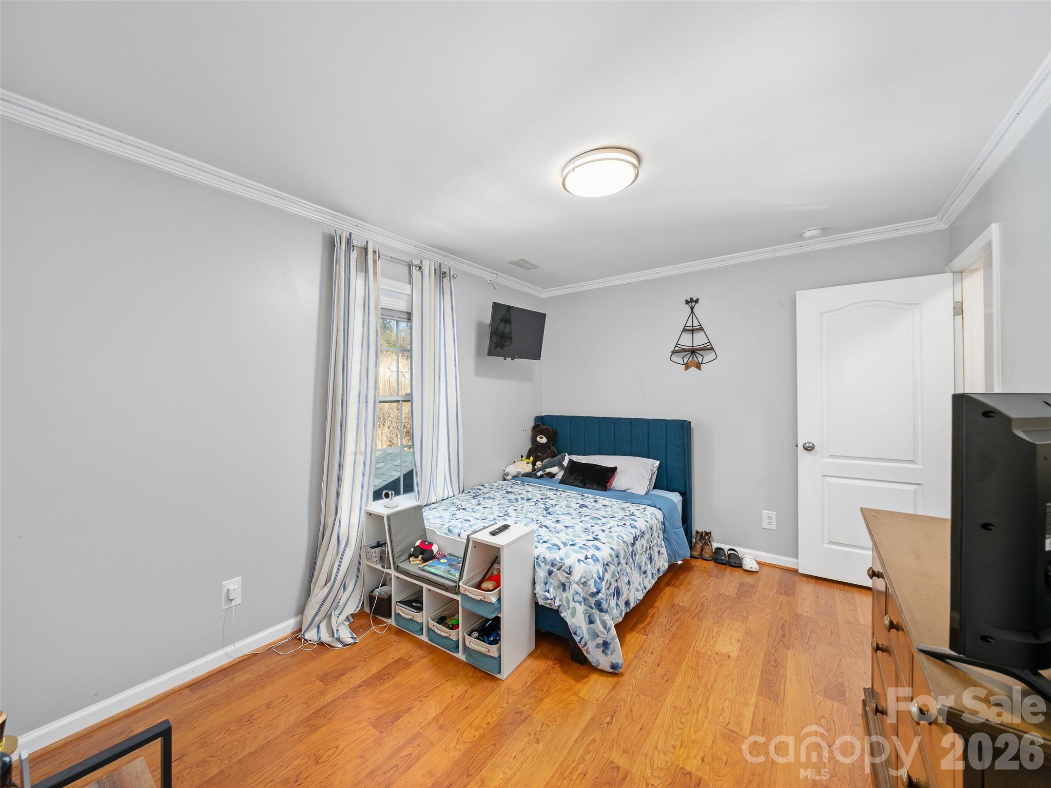221 Creed Pitman Road Spruce Pine, NC 28777 - Photo 22 of 27 a bedroom with a bed and a flat screen tv
