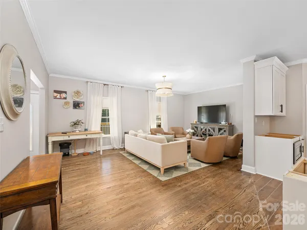 a living room with furniture fireplace and a window