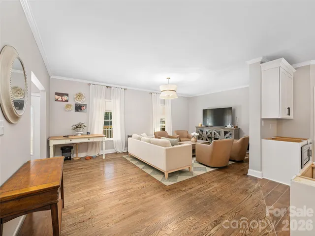 a living room with furniture fireplace and a window