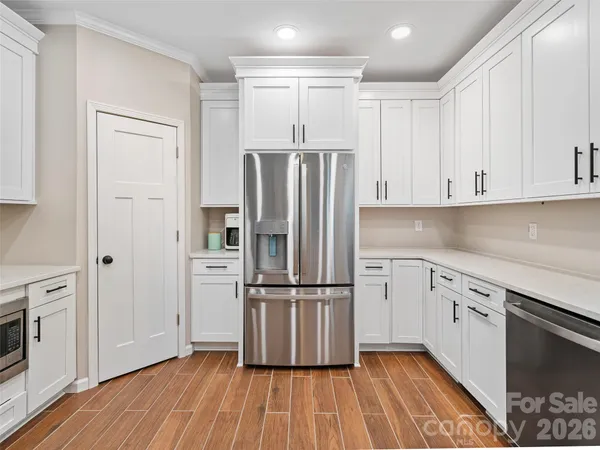 a kitchen with stainless steel appliances granite countertop a refrigerator and a stove top oven