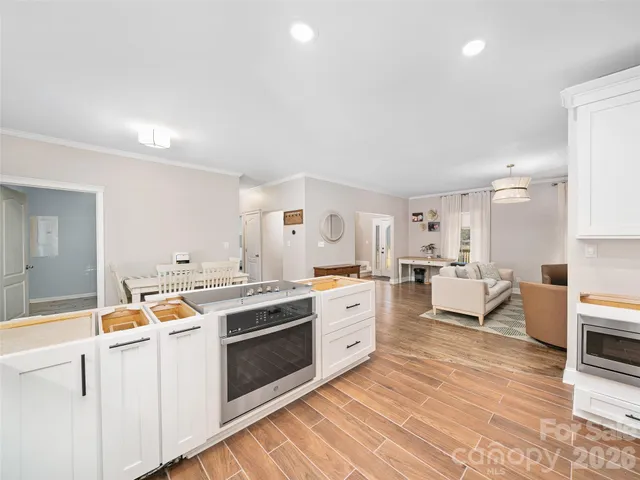 a kitchen with stainless steel appliances a stove a sink and a refrigerator