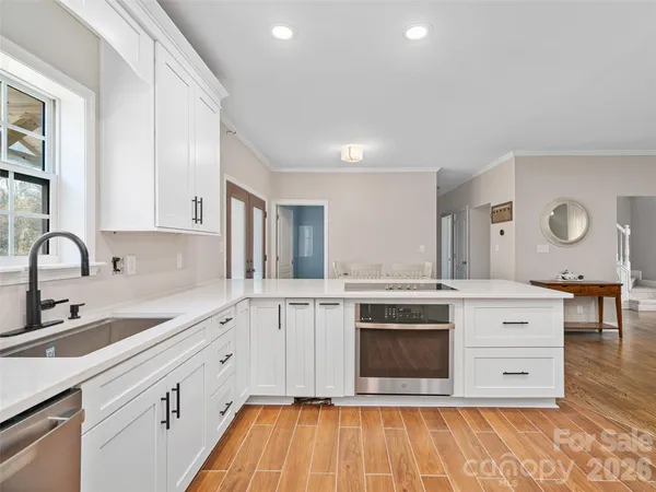 a kitchen with stainless steel appliances granite countertop a stove a sink and a refrigerator