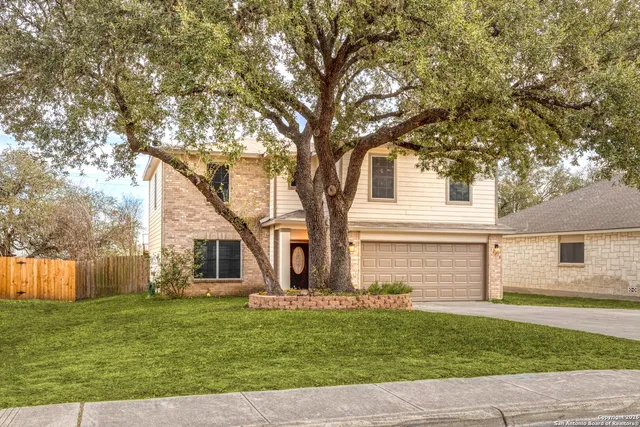a front view of a house with a garden and yard