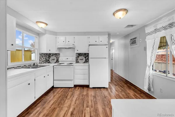 a kitchen with white cabinets and white appliances