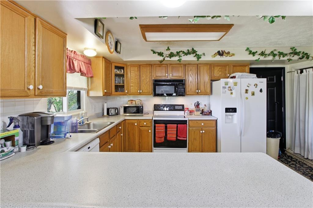 776 Fraction Road West Finley, PA 15377 - Photo 19 of 43 a kitchen with stainless steel appliances a stove a sink a refrigerator and a microwave