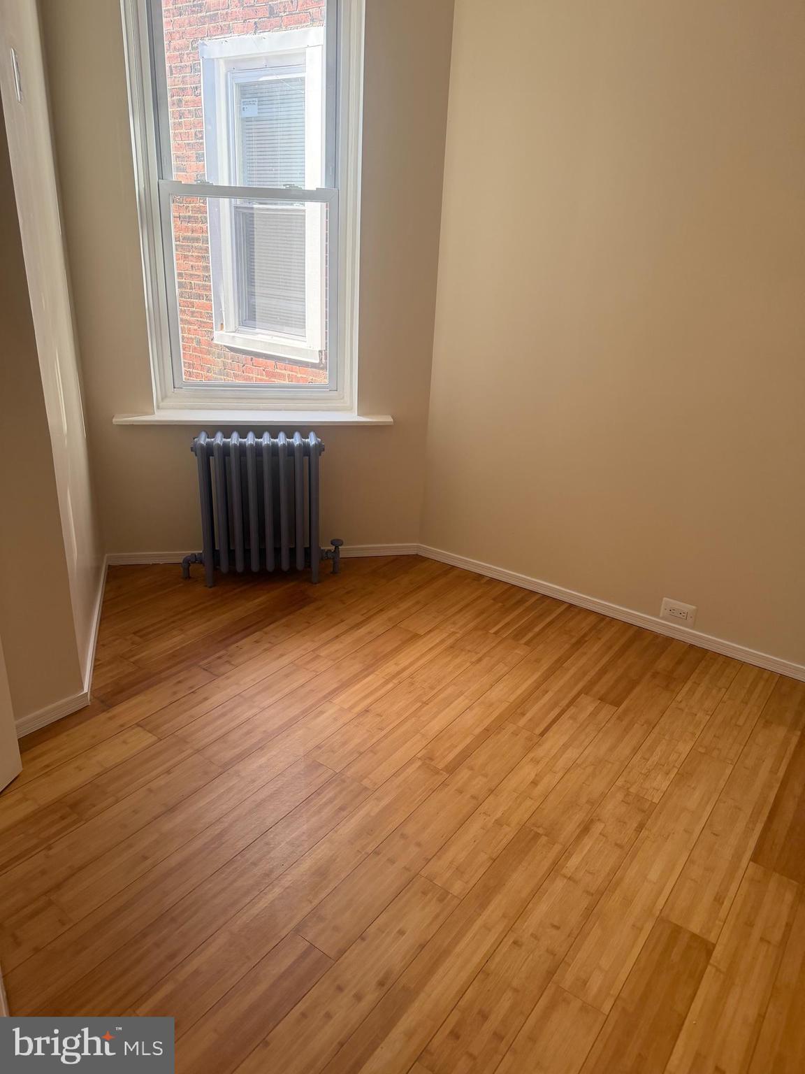 1940 South 57th Street Philadelphia, PA 19143 - Photo 11 of 26 an empty room with wooden floor and windows