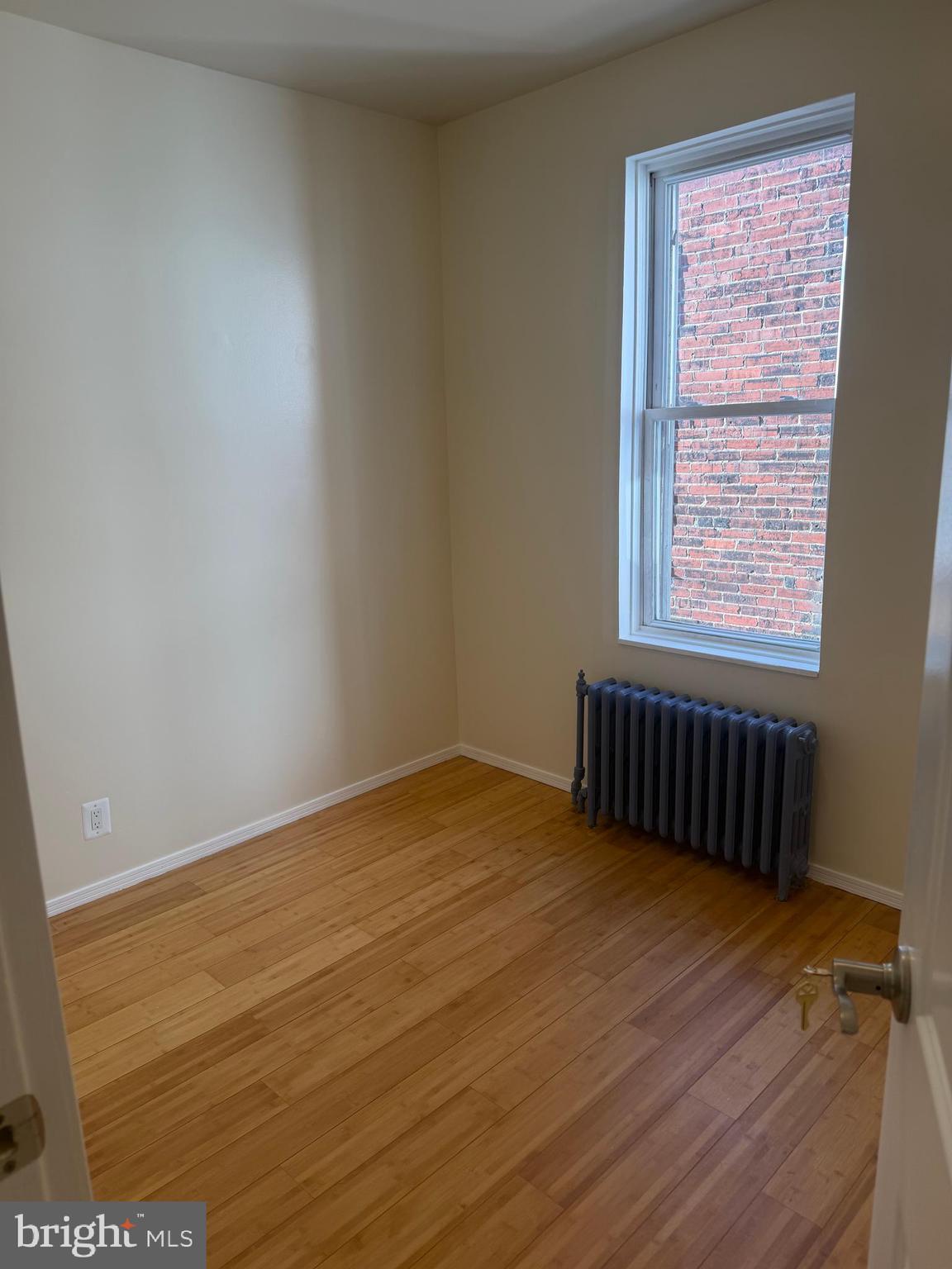 1940 South 57th Street Philadelphia, PA 19143 - Photo 14 of 26 a view of an empty room with wooden floor and a window