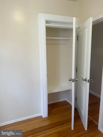 a view of a room with wooden floor and pool table