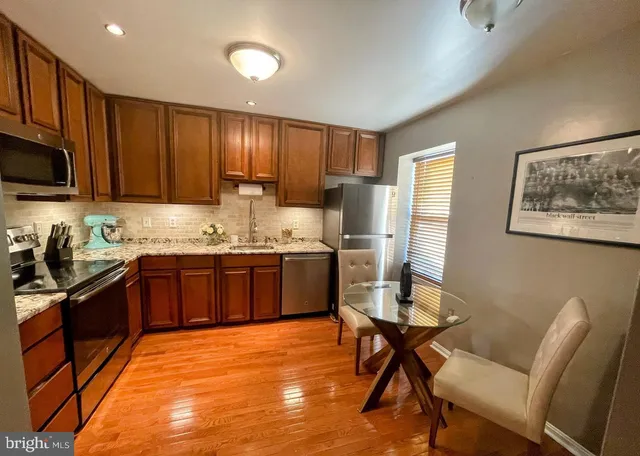 a kitchen with a refrigerator stove and sink