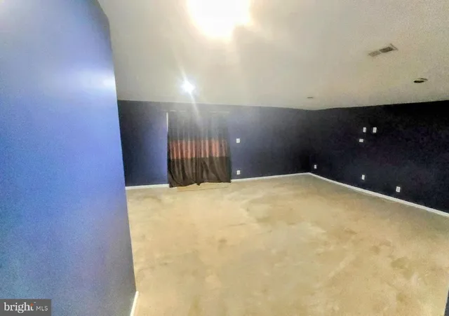 a view of a livingroom with furniture and a kitchen