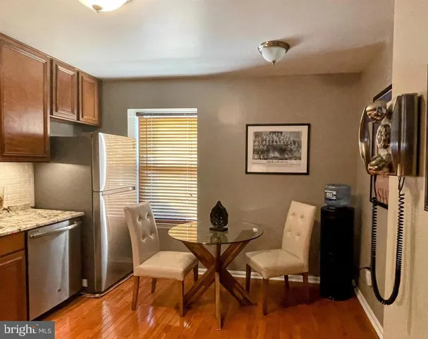 a kitchen with granite countertop wooden cabinets stainless steel appliances and a sink