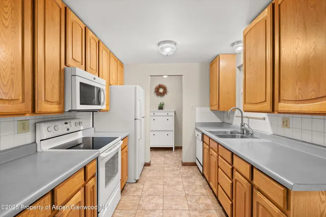 a bathroom with a double vanity sink a mirror and a bathtub