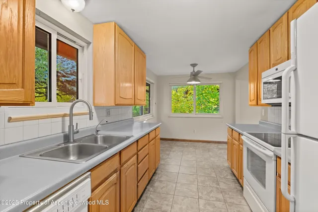 a kitchen with stainless steel appliances a sink a stove and a window