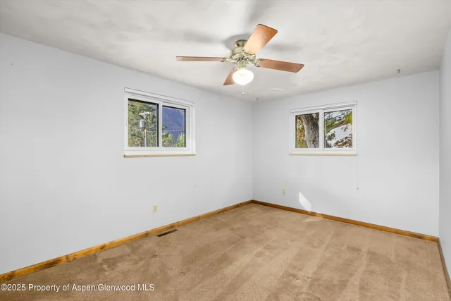 a view of an empty room with a window