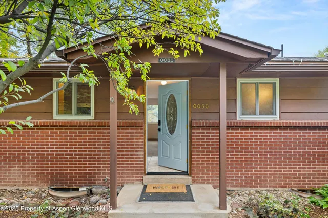 a view of a brick house with a large windows