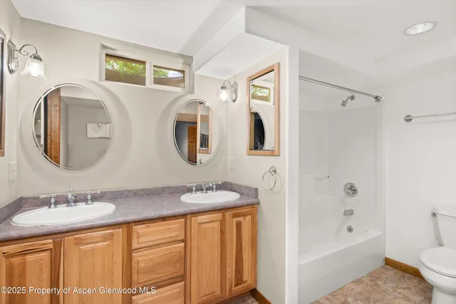 a spacious bathroom with a granite countertop sink and a mirror