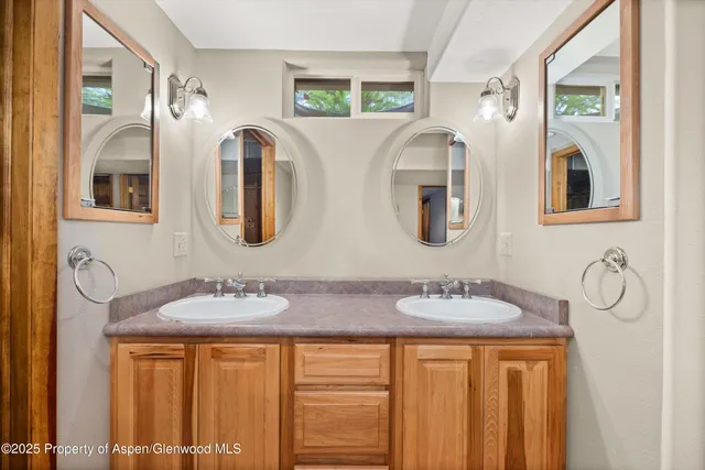 a bathroom with 2 sink and a mirror