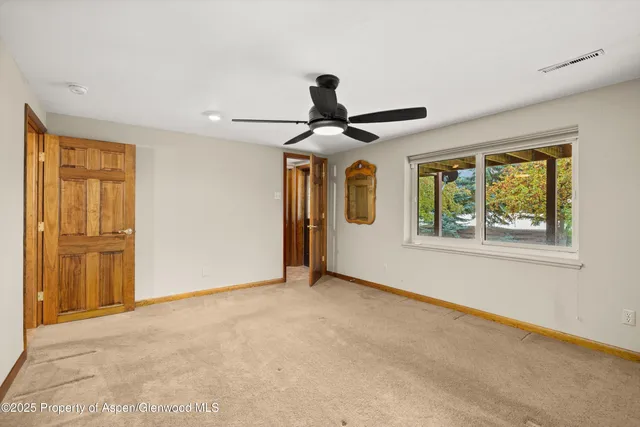 a view of an empty room with a window