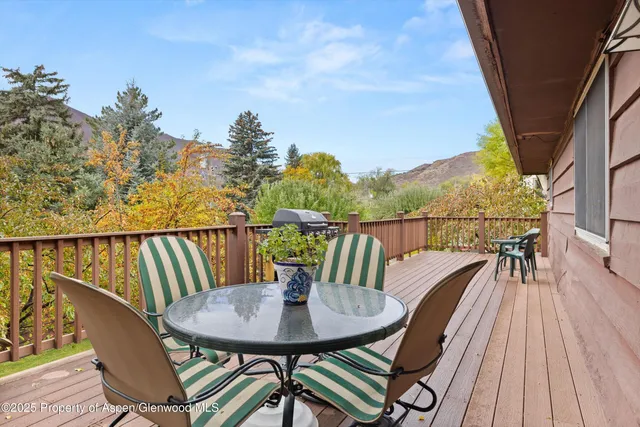 a view of a balcony with mountain and wooden floor