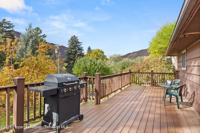 a view of balcony with wooden floor and fence