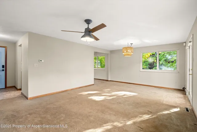 a view of a livingroom with a ceiling fan and window