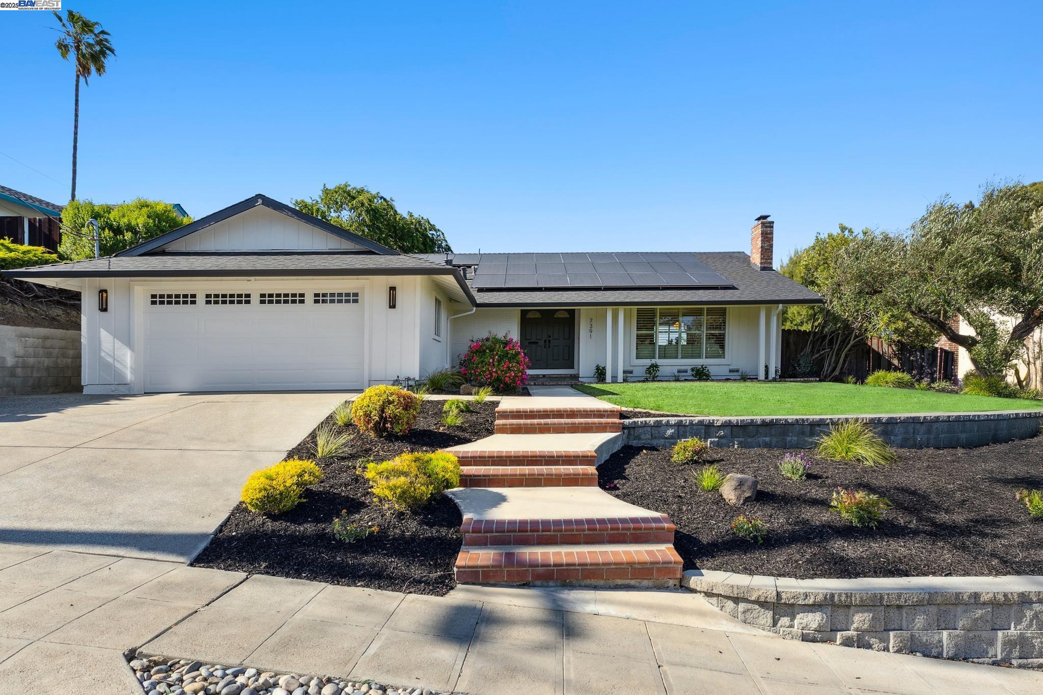 a front view of a house with a garden