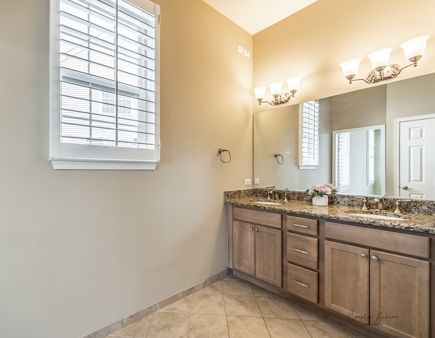 3870 Eagle Ridge Drive Elgin, IL 60124 - Photo 11 of 20 a bathroom with a granite countertop sink a mirror and a window