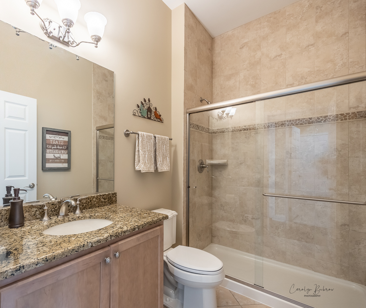 3870 Eagle Ridge Drive Elgin, IL 60124 - Photo 16 of 20 a bathroom with a granite countertop sink toilet and shower