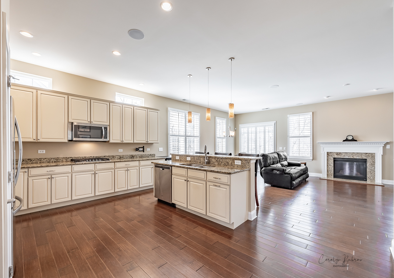 3870 Eagle Ridge Drive Elgin, IL 60124 - Photo 5 of 20 a kitchen with a refrigerator a stove a sink and white cabinets with wooden floor