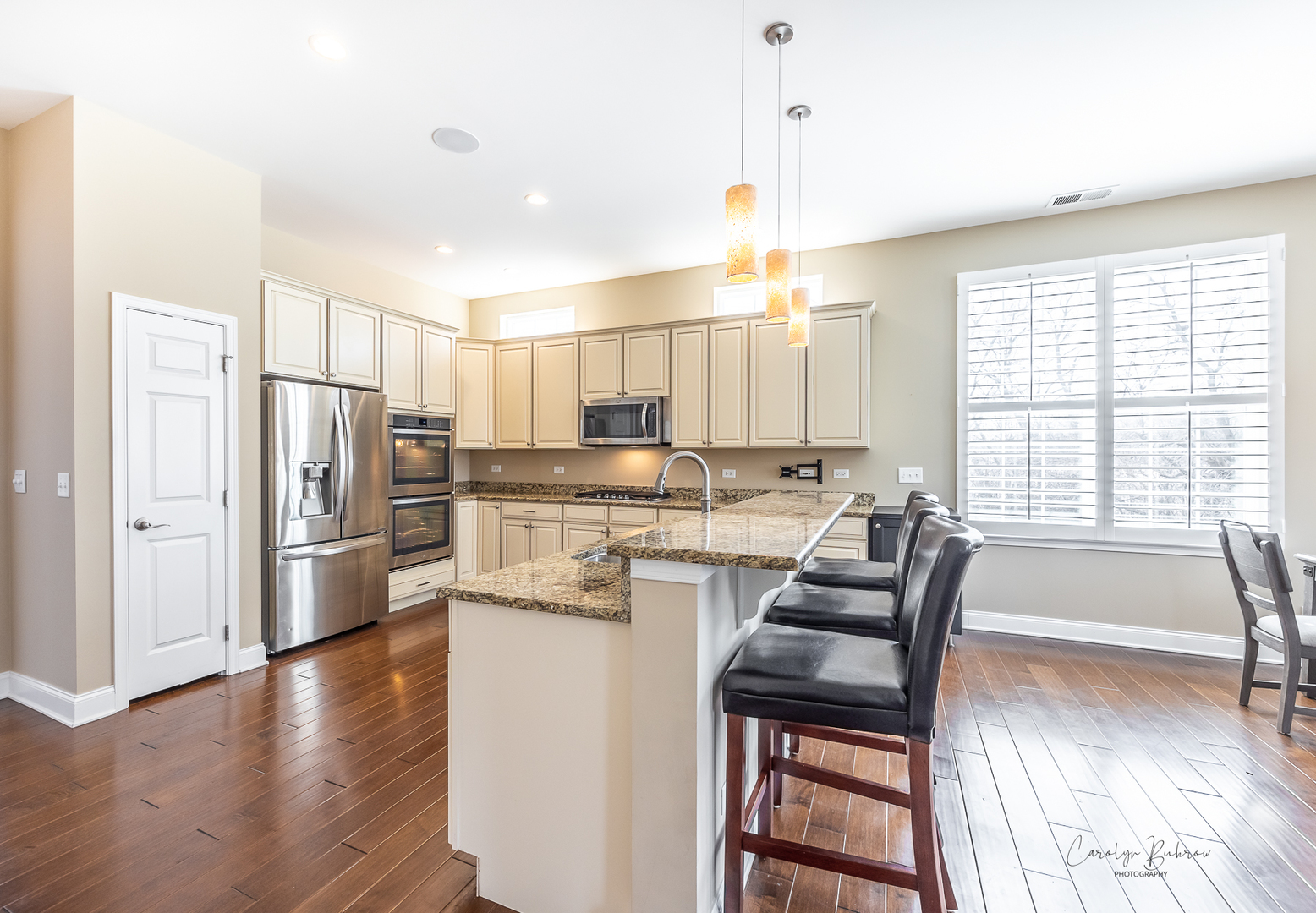 3870 Eagle Ridge Drive Elgin, IL 60124 - Photo 6 of 20 a kitchen with refrigerator cabinets and wooden floor