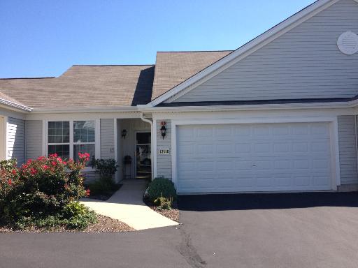 13616 Hemlock Road Huntley, IL 60142 - Photo 1 of 16 a front view of a house with garden