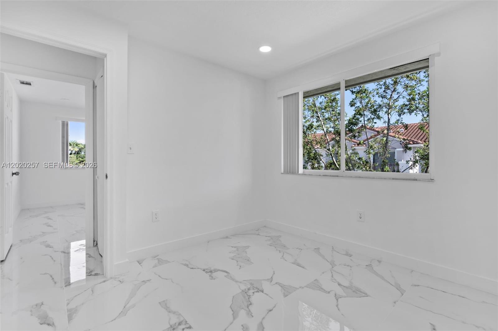 10245 Southwest 154th Place, Unit 1123 Miami, FL 33196 - Photo 28 of 38 an empty room with a window