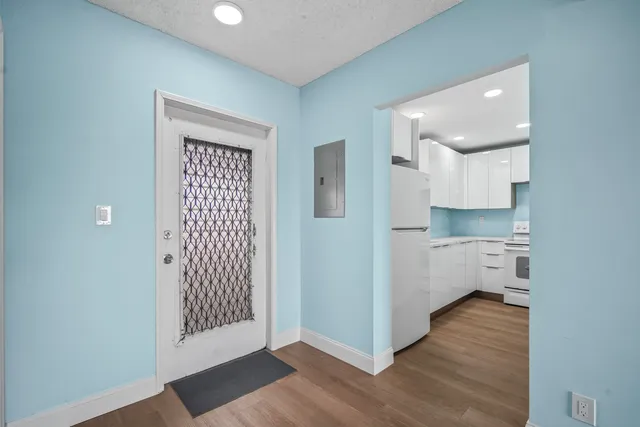 a view of a kitchen with wooden floor and a sink