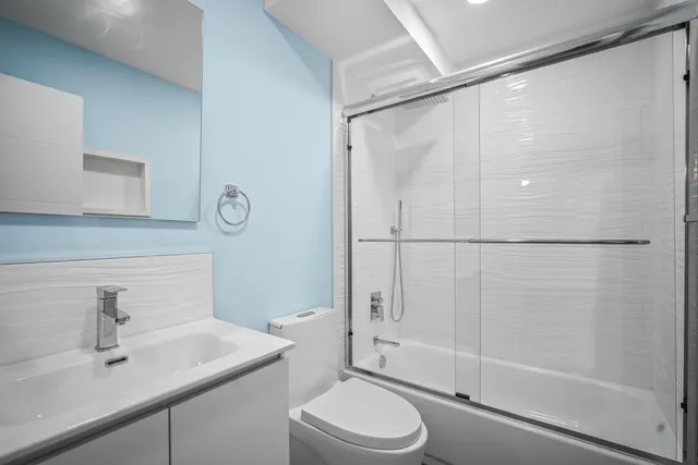a bathroom with a sink toilet and shower