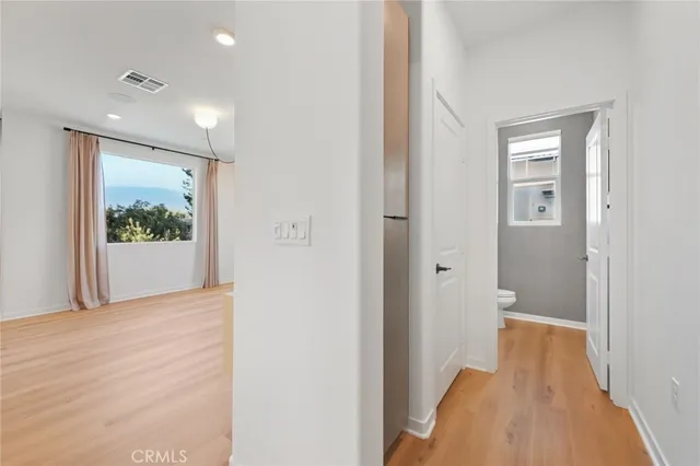a view of a hallway with wooden floor and a fireplace