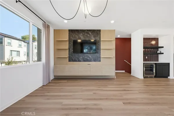 a kitchen with stainless steel appliances granite countertop a sink a stove and a wooden floors