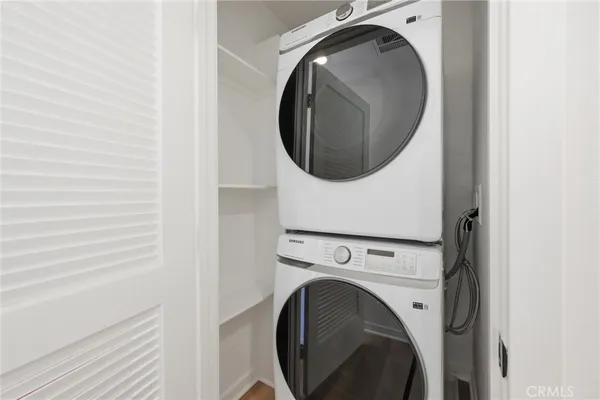 a view of a patio with couches and table under an umbrella