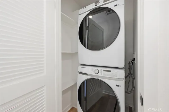 a view of a patio with couches and table under an umbrella