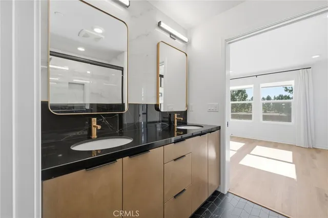 a front view of a house with garden and sitting area