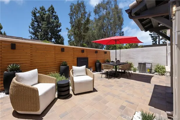 a living room with stainless steel appliances kitchen island furniture and wooden floor